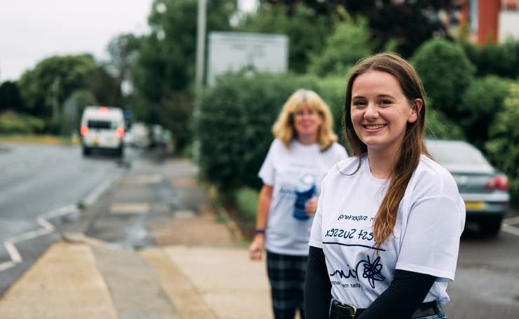 Two women in West Sussex Mind supporters' T-shirts outside on a street