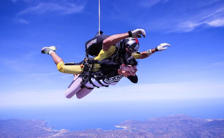 Tandem skydive with deep blue sky to background