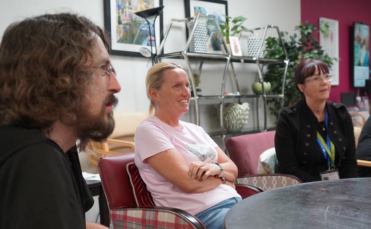 Three people listen at a mental health workshop with West Sussex Mind