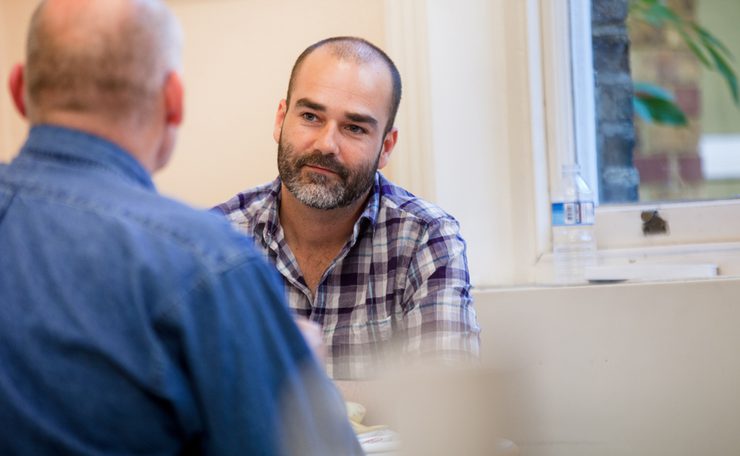 Man listens to another man speaking