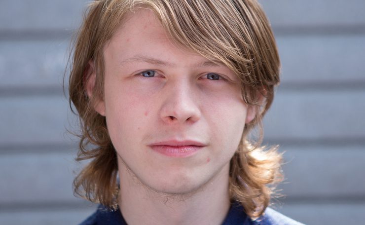 Young man looks to camera