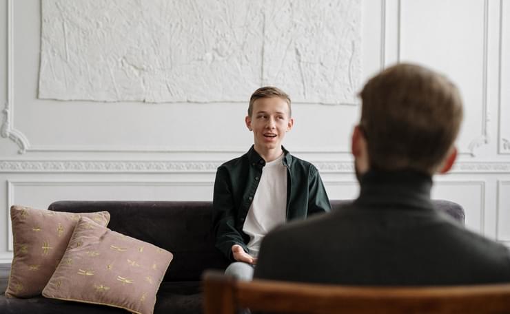 young lad speaking to man inside