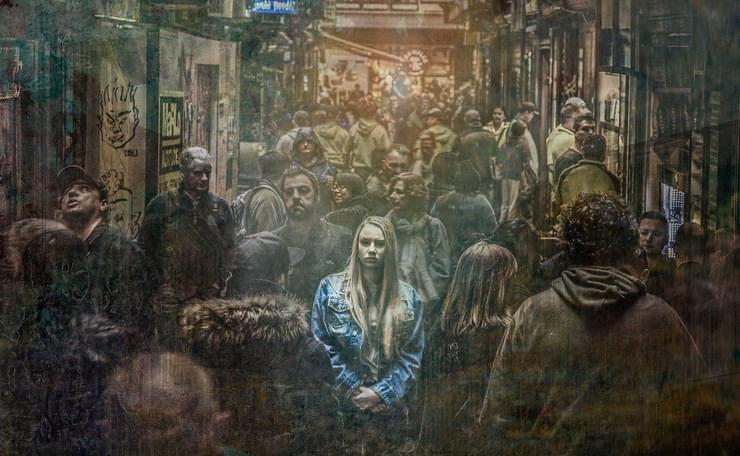 woman feeling lonely in a crowded street