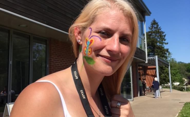Support worker Kim with face painting smiles to camera