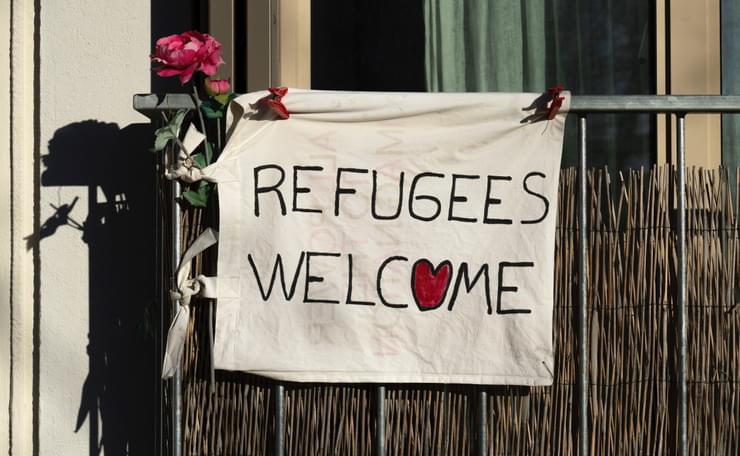 Sign outside window saying refugees welcome