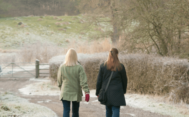 Two women walking in the countryside